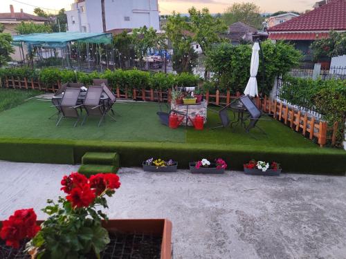 a patio with chairs and flowers and an umbrella at Jennys Vintage Studio - Motorcycle Friendly in Drama