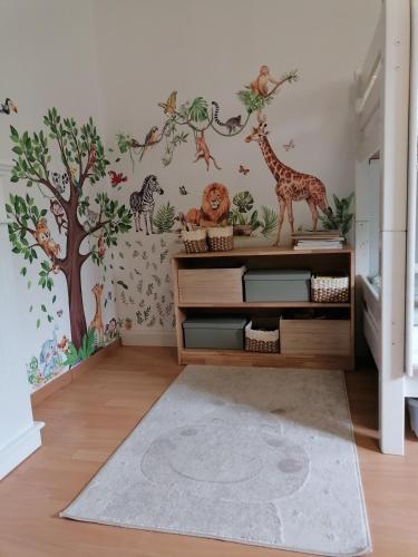 a childs room with a safari mural on the wall at Thomas Haus 1 in Günzburg