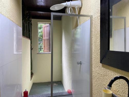 a bathroom with a shower with a glass door at Casa Sankofa de Belém in Belém