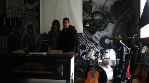 a man and a woman standing in a room with guitars at Anahuaska Art - Suites Temáticas in Panzares