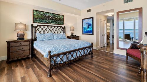 a bedroom with a bed and a table and a chair at 334 Mariners Club in Key Largo