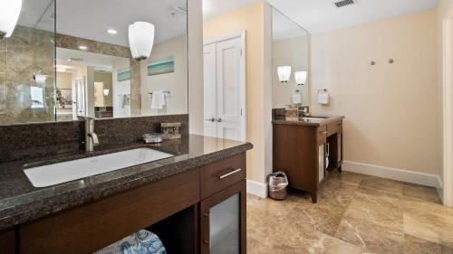 a bathroom with a sink and a large mirror at 334 Mariners Club in Key Largo