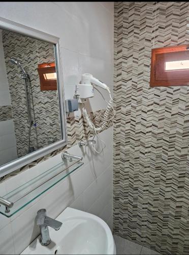 a bathroom with a sink and a mirror at Hotel liberté 6 in Dakar