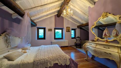 a bedroom with a bed and a dresser with a mirror at Chambres d'Hotes Quart de Lune in Quart