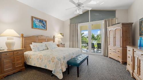 a bedroom with a bed and a sliding glass door at 405 Mariners Club in Key Largo