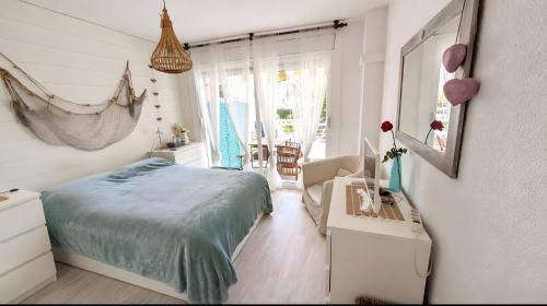 a bedroom with a bed and a chair in it at Apartamento Mar y Encanto in Miami Platja
