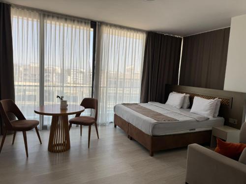 a hotel room with a bed and a table and chairs at Alya Rooms in Lefkosa Turk