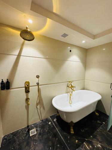 a bathroom with a bath tub in a room at Vetiver Grand in Jabalpur