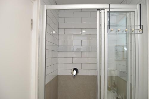 a shower with a glass door in a bathroom at Luxury Apartment Unit 101 in George