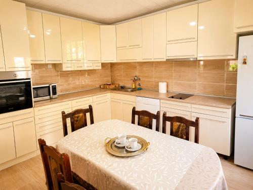 a kitchen with a table with a plate on it at Udoban porodični apartman ViS Raška, 80m2, parking, bašta in Raška