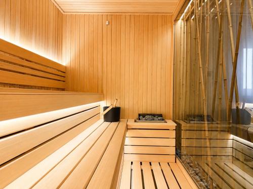 a sauna with wooden walls and a wooden floor at Atera Business Suites in Belgrade