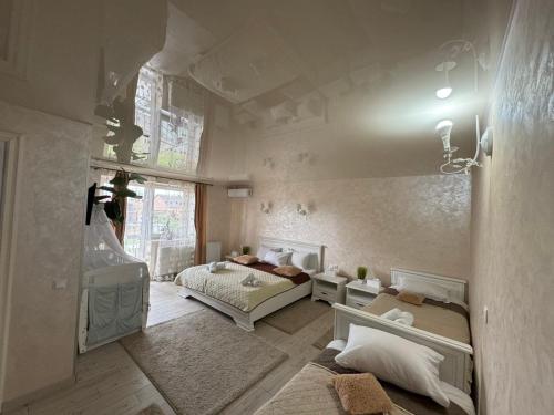 a bedroom with two beds and a window at Hotel DALIM in Duliby