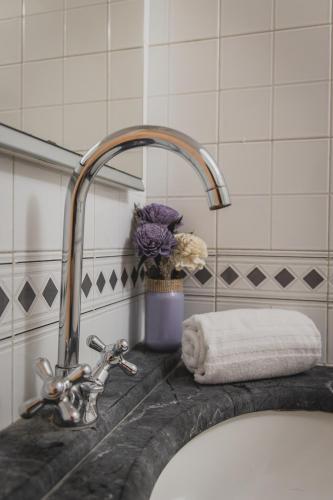 a bathroom sink with a faucet and a towel at Residenza d'Epoca " Il Campo" by FrancigenaApartments in Siena