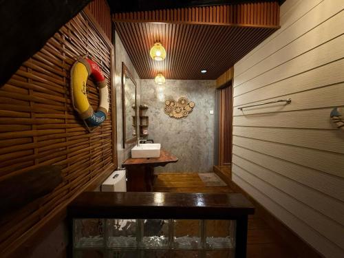 a bathroom with a sink and a wooden wall at Little Rock Kohjum in Ko Jum