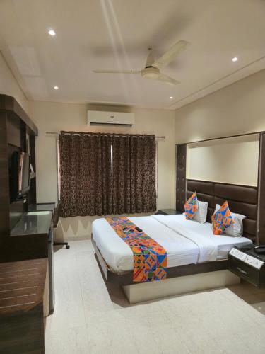 a bedroom with a large bed and a window at Hotel Santoor - Geeta Bhawan Square in Indore