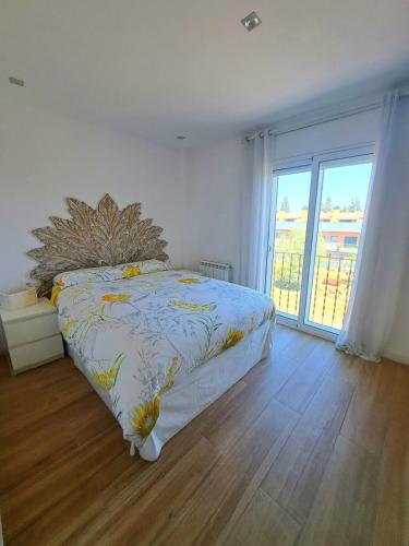 a bedroom with a bed and a large window at Vivalidays Elisabet in Palafolls