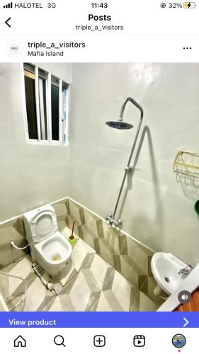 a bathroom with a toilet and a lamp and a sink at Triple A visitors in Kilindoni