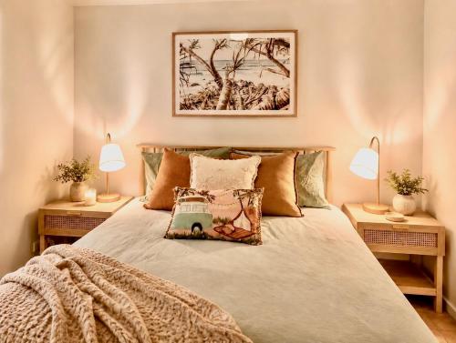 a bedroom with a large bed with two lamps at Blue Waters - Beachfront and River View - Sleeps 6 -Central Kalbarri in Kalbarri
