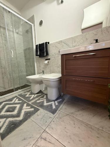 a bathroom with a toilet and a sink and a shower at La Roccia in Reggio di Calabria