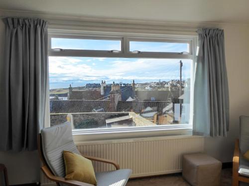 a window with a view of a city at Crail House in Crail