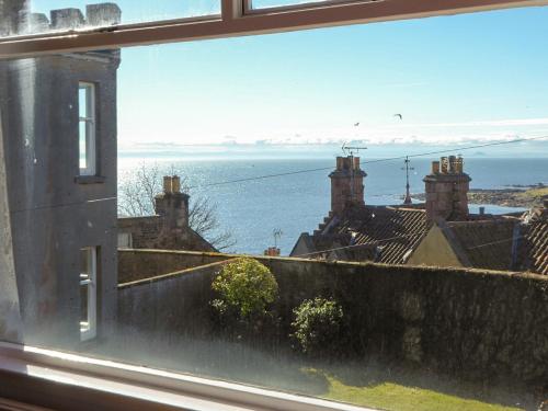 a view of the ocean from a window at Crail House in Crail