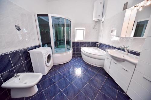 a bathroom with two sinks and two toilets at Penthouse S in Bar
