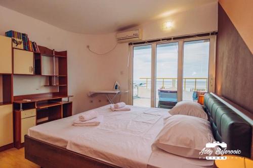 a bedroom with a large bed and a large window at Penthouse S in Bar