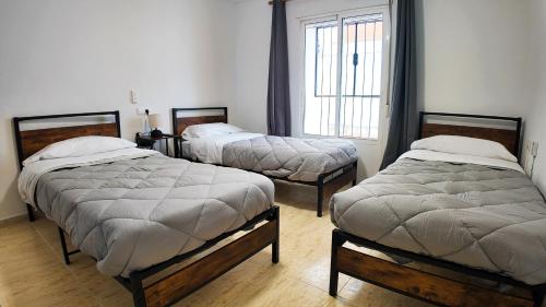 a room with two beds and a window at Ruralux Sierra Quesada in Quesada