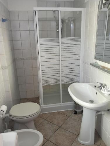 a bathroom with a shower and a toilet and a sink at Sleep & Fly Studio Smart in Case Nuove