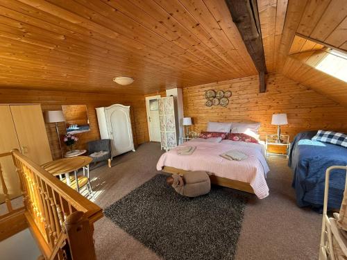 a bedroom with a bed in a wooden cabin at Chalupa V soukromí - Chřibská in Chřibská