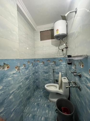 a bathroom with a fish mural on the wall at Hotel South embassy near Durgabai dekhmukh metro in New Delhi