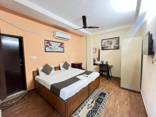 a bedroom with a bed with a ceiling fan at Hotel South embassy near Durgabai dekhmukh metro in New Delhi
