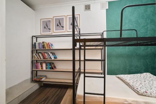 a bedroom with a bunk bed and a book shelf at Apartament Gold 3 in Złotoryja