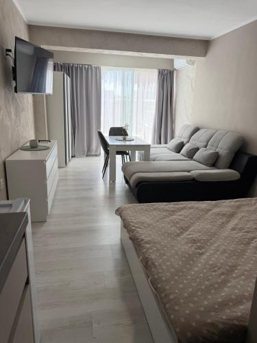 a living room with two beds and a table at Complex Yavor in Aheloy