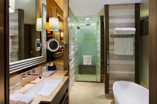 a bathroom with a sink and a toilet and a shower at Crowne Plaza Nanjing Jiangning by IHG in Nanjing