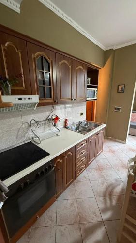 a kitchen with a sink and a stove top oven at Villa Gersina Golem in Golem