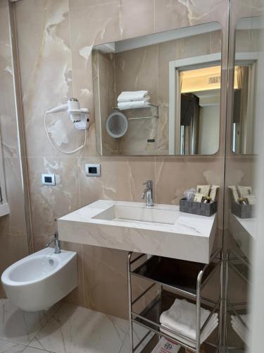 a bathroom with a sink and a mirror and a toilet at Guest House Broletto in Milan