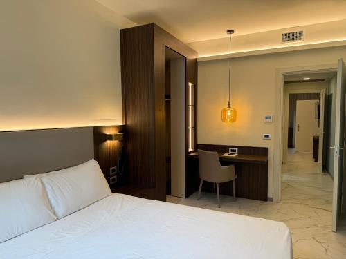 a bedroom with a bed and a desk with a chair at Guest House Broletto in Milan