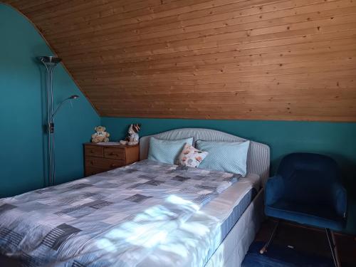 a bedroom with a bed with a wooden ceiling at Tőserdő in Lakitelek