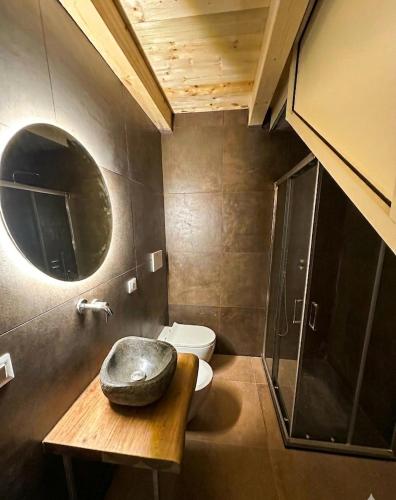 a bathroom with a toilet and a sink and a mirror at Be Local-Avola stay in Avola