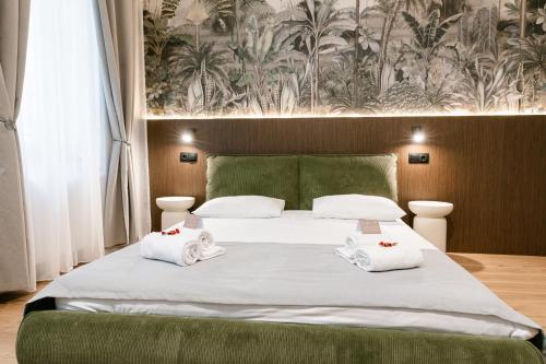 a bedroom with a bed with towels on it at Flowers House Sibiu in Sibiu