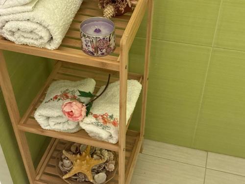 a wooden shelf with towels and towels on it at Krasi Apartments in Perla Complex in Pomorie