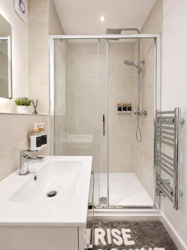 a bathroom with a sink and a shower at Flat 7 in central Bromley - underground parking in Bromley