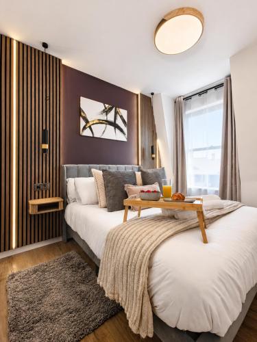 two beds in a bedroom with a table on top at Flat 7 in central Bromley - underground parking in Bromley