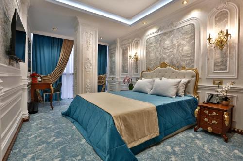 a bedroom with a blue bed in a room at Alermo Hotel-SPA in Baku
