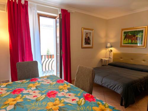 a bedroom with a table and a bed and a window at Europa Casa Vacanze in Villetta Barrea