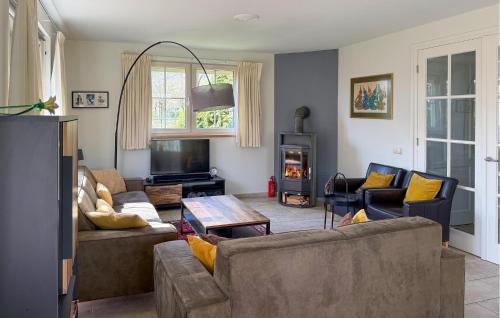 a living room with two couches and a tv at Horsterhoek in Zeewolde