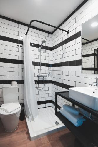 a bathroom with a shower and a sink and a toilet at Alma Candida 21 in Valença