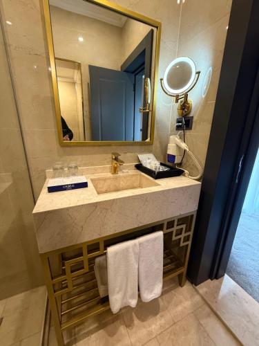 a bathroom with a sink and a mirror at Crixus Hotels Sarsing in Sarsing