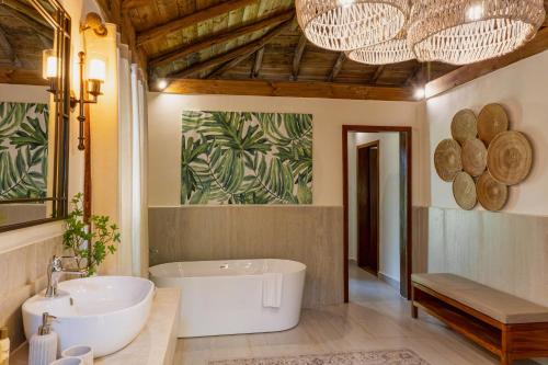 a bathroom with a large tub and a sink at The Palms Zanzibar in Bwejuu